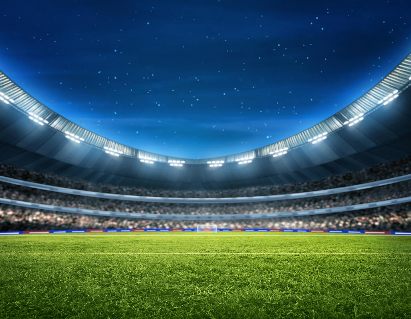 Stade de Bordeaux lit up at night under a starry sky, with an impeccable pitch, suggesting an evening match atmosphere, close to the appart'hôtel Bordeaux, convenient for visitors looking for accommodation close to the sporting event.