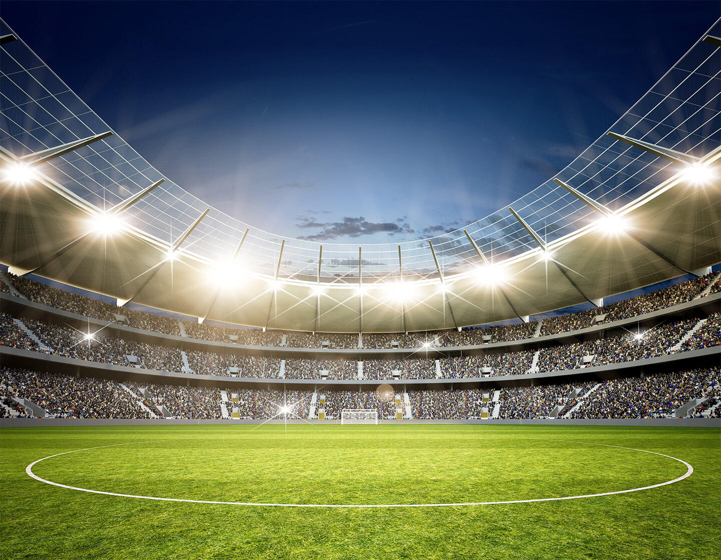 Modern floodlit football stadium, with stands full of spectators, located close to the Appart'City apartment hotel in Nice, offering an ideal setting for sports fans staying in the city.